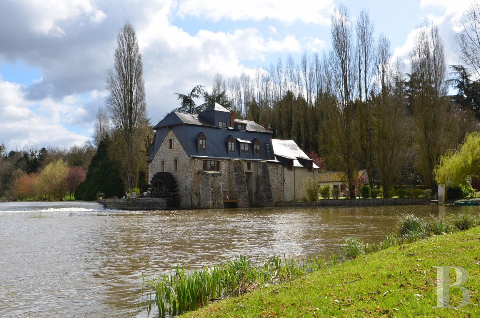 A renovated, 17th century mill, like a liner protruding from the waves